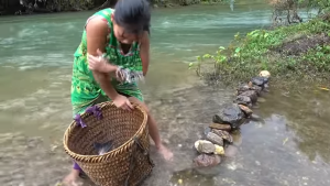in a daring feat of fishing a brave girl catches a massive anaconda in a deep hole video 407932 1